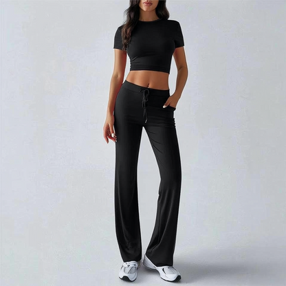 Person wearing a black athletic outfit on a plain background